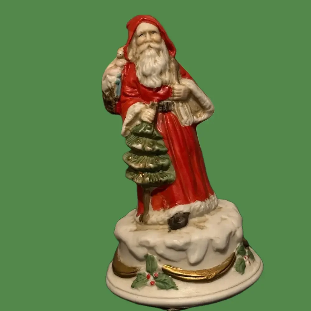 Revolving porcelain Santa musical figure plays Santa Claus is Coming to Town.